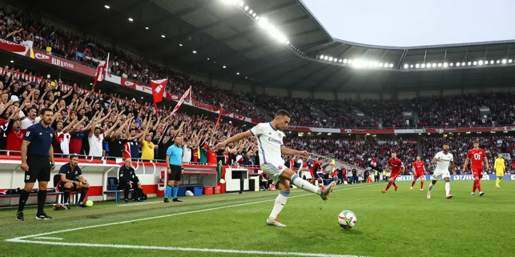 Exciting football match showing supporters in jerseys and a player preparing to kick, focusing on the TOP10 สโมสร.