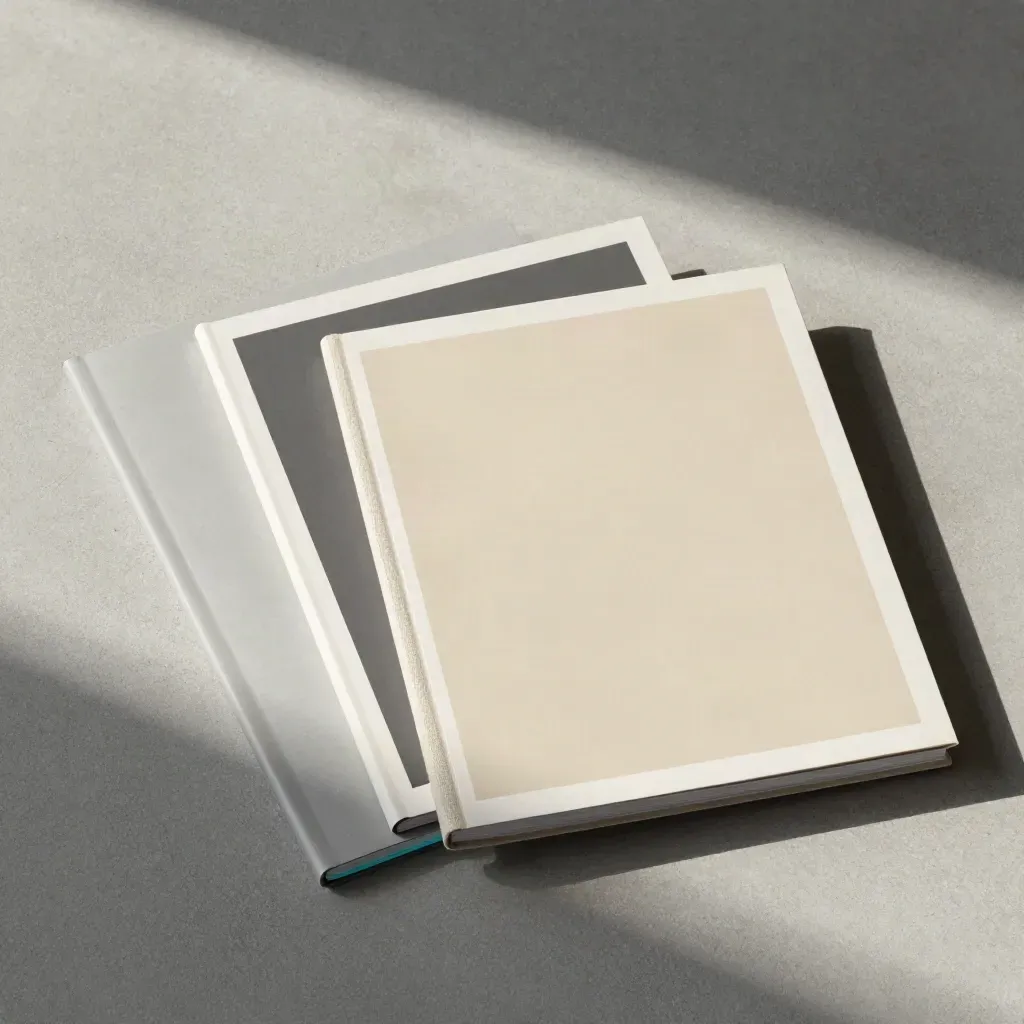 Overhead flatlay of nested hero boards and a slim folio on cool concrete